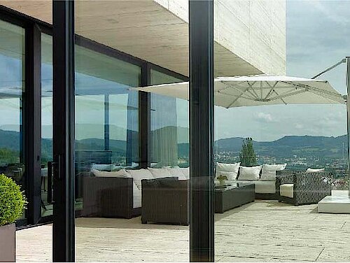 Blick auf eine Dachterrasse durch Alu-Fenster von Schüco im Weitwinkel